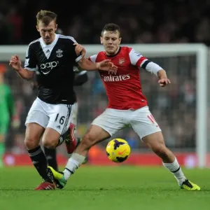 Clash of Midfield Titans: Wilshere vs Ward-Prowse in Arsenal vs Southampton, Premier League 2013-14