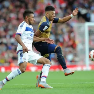 Clash of Midfielders: Oxlade-Chamberlain vs. Tolisso in Arsenal's Emirates Cup Match