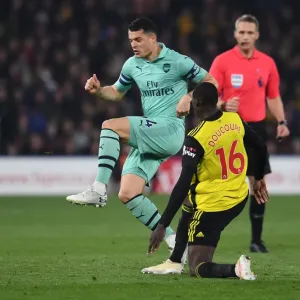 Clash at Vicarage Road: Xhaka vs. Doucoure in the Premier League Battle between Watford and Arsenal