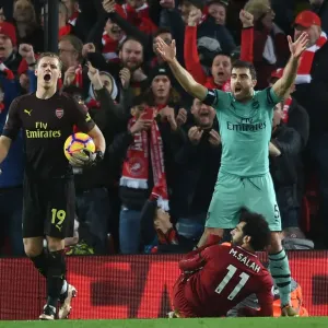 Controversial Penalty Call: Sokratis and Leno Protest as Mo Salah Scores for Liverpool Against Arsenal