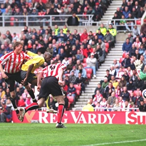 Danny Collins (Sunderland) heads into his own goal under pressure from Abu Diaby for the 1st Arsenal