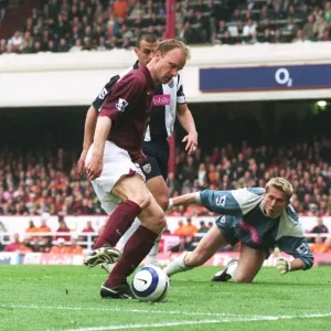 Dennis Bergkamp takes the ball away from Neil Clement and Tomasz Kuszczak