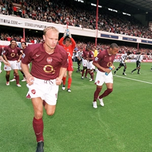 Dennis Bergkamp and Thierry Henry (Arsenal) run out at the start of the match