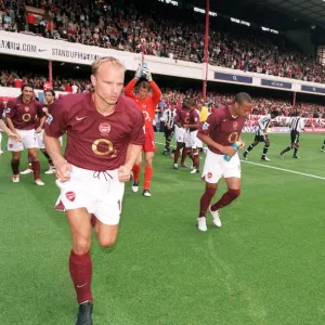 Dennis Bergkamp and Thierry Henry (Arsenal) run out at the start of the match