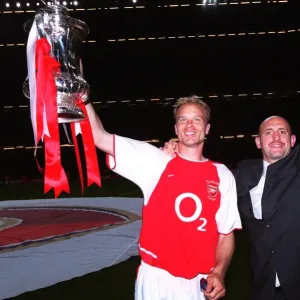 Dennis Bergkamp and Tony Colbert (Arsenal) with the FA Cup Trophy Dennis Bergkamp and Tony Colbert (Arsenal) with the FA Cup Trophy