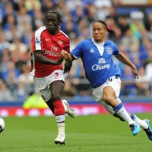 Dominance on the Field: Sagna and Pienaar Clash in Arsenal's 6-1 Victory over Everton, 2009