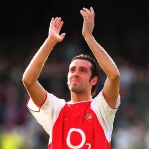 Print of Edu clapping fans after match