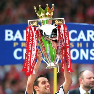 Edu lifts the F. A. Barclaycard Premiership Trophy