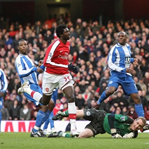 Emmanual Adebayor shoots past Wigan goalkeeper Chris