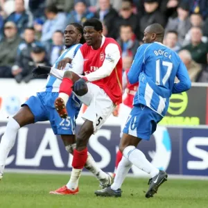 Emmanuel Adebayor (Arsenal) Mario Melchiot and Emmerson Boyce (Wigan) Emmanuel Adebayor (Arsenal) Mario Melchiot and Emmerson Boyce (Wigan)