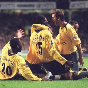 Emmanuel Adebayor celebrates scoring Arsenals goal with Johan Djourou