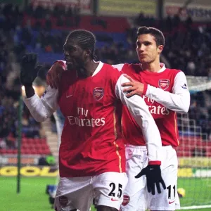 Emmanuel Adebayor celebrates scoring Arsenals goal with Robin van Persie