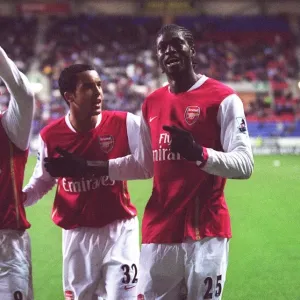Emmanuel Adebayor celebrates scoring Arsenals goal with Theo Walcott