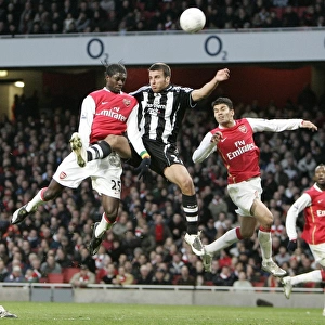 Emmanuel Adebayor and Eduardo (Arsenal) jump with Steven Taylor (Newcastle)