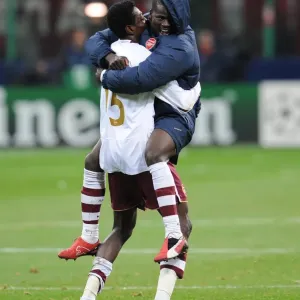 Emmanuel Adebayor and Emmanuel Eboue celebrate Arsenals victory
