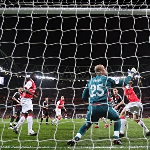 Emmanuel Adebayor heads past Liverpool Pepe Reina to scote the Arsenal goal