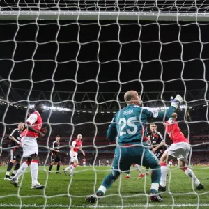 Emmanuel Adebayor heads past Liverpool Pepe Reina to scote the Arsenal goal