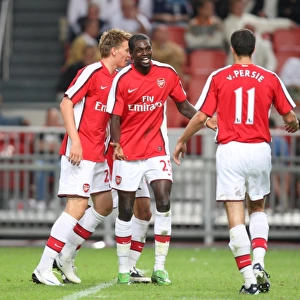Emmanuel Adebayor and Robin van Persie celebrate Arsenal s