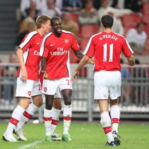 Emmanuel Adebayor and Robin van Persie celebrate Arsenal s