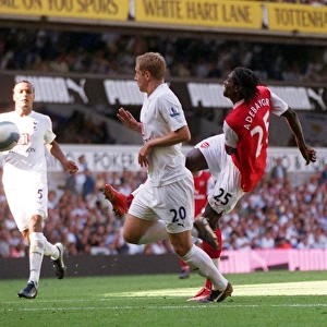 Emmanuel Adebayor scores Arsenals 3rd goal under pressure from Michael Dawson