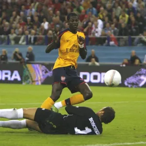 Emmanuel Adebayor shoots past FC Twente goalkeeper Emmanuel Adebayor shoots past FC Twente goalkeeper