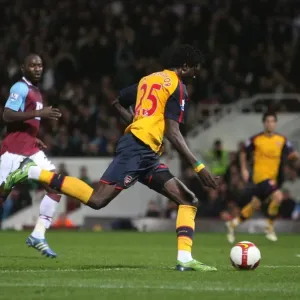 Emmanuel Adebayor shoots past Herita Ilunga to score Emmanuel Adebayor shoots past Herita Ilunga to score