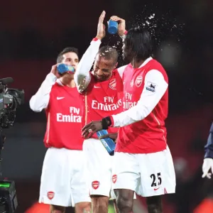 Emmanuel Adebayor squirts water at Thierry Henry (Arsenal) at the end of the match