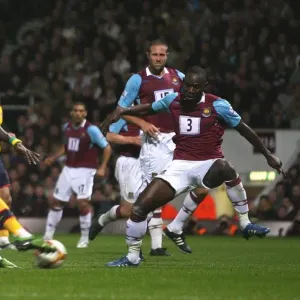 Emmanuel Adebayors shot hits West Hams Julien Flaubert Emmanuel Adebayors shot hits West Hams Julien Flaubert