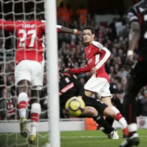 Emmanuel Eboue (Arsenal) accidentally blocks a goalbound shoot from Cesc Fabregas