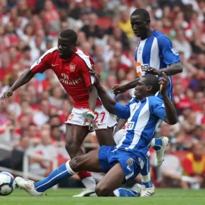 Emmanuel Eboue (Arsenal) Hendry Thomas and Mohamed Diame (Wigan) Emmanuel Eboue (Arsenal) Hendry Thomas and Mohamed Diame (Wigan)