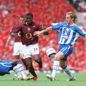 Emmanuel Eboue (Arsenal) Henri Camara and Reto Ziegler (Wigan) Emmanuel Eboue (Arsenal) Henri Camara and Reto Ziegler (Wigan)