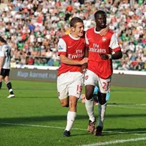 Emmanuel Eboue celebrates scoring the 3rd Arsenal goal with Jack Wilshere