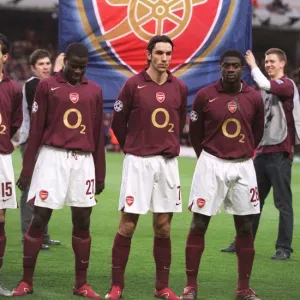 Emmanuel Eboue, Robert Pires and Kolo Toure (Arsenal) line up with an banner behind them