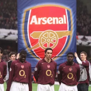 Emmanuel Eboue, Robert Pires and Kolo Toure (Arsenal) line up with an banner behind them