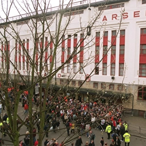 Fans gather outside the East Stand on Avenell Road to watch the Arsenal team arrive at the stadium