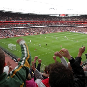 Fans jump up in the upper terrace to celebrate Emmanuel Adebayor scoring Arsenals 1st goal