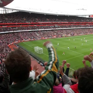Fans jump up in the upper terrace to celebrate Emmanuel Adebayor scoring Arsenals 1st goal Fans jump up in the upper terrace to celebrate Emmanuel Adebayor scoring Arsenals 1st goal