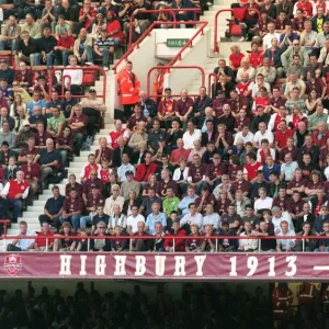 Fans in the North Bank sit above the 1913 - 2006 banner