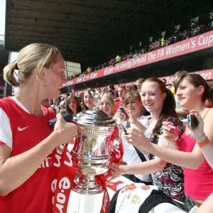Faye White (Arsenal) shows of the troph to the fans
