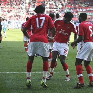 Fourth Goal Celebration: Alex Song, Emmanuel Adebayor, and Kolo Toure, Arsenal's Winning Moment against Wigan Athletic in the Premier League