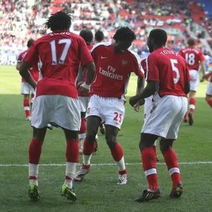Fourth Goal Celebration: Alex Song, Emmanuel Adebayor, and Kolo Toure, Arsenal's Winning Moment against Wigan Athletic in the Premier League