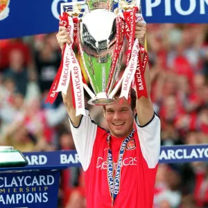 Fredrik Ljungberg lifts the F. A. Barclaycard Premiership Trophy
