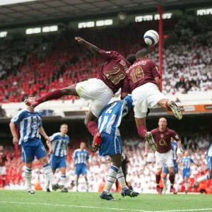 Gilberto and Kolo Toure (Arsenal) jump for the ball with Pascal Chimbonda (Wigan)