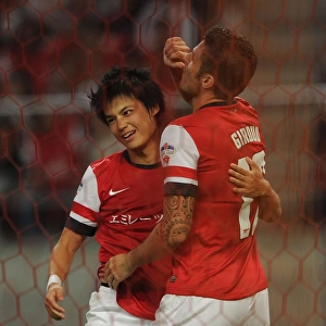 Giroud and Miyaichi Celebrate Goal: Nagoya Grampus vs. Arsenal, 2013