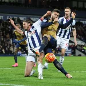Giroud vs Evans: A Premier League Battle - Intense Tackle Between Arsenal's Star Forward and West Brom's Defender Giroud vs Evans: A Premier League Battle - Intense Tackle Between Arsenal's Star Forward and West Brom's Defender