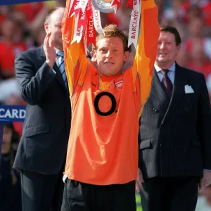 Graham Stack (Arsenal) lifts the Premiership Trophy. Arsenal v Leicester City