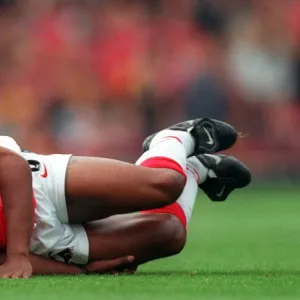 Ian Wright (Arsenal) on the floor injured