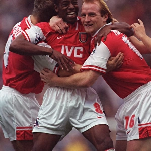 Ian Wright celebrates scoring for Arsenal with John Hartson and Paul Merson