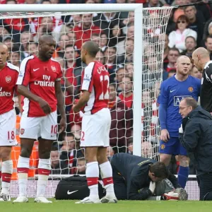 Injured Arsenal goalkeeper Manuel Almunia is treated