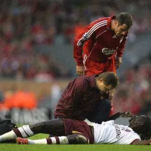 Injured Emmanuel Adebayor is treated by Arsenal physio Gary Lewin